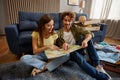 Happy loving couple looking at paper map planning travel at home Royalty Free Stock Photo