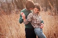 Happy loving couple on the walk in early spring field Royalty Free Stock Photo