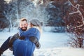 Happy Loving Couple Walking In Snowy Winter Forest, Spending Christmas Vacation Together.