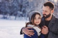 Happy loving couple walking in snowy winter forest, spending christmas vacation together. Outdoor seasonal activities Royalty Free Stock Photo