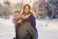 Happy loving couple walking in snowy winter forest, spending christmas vacation together. Outdoor seasonal activities.