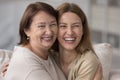 Happy elder mom embracing beautiful adult daughter woman with joy Royalty Free Stock Photo