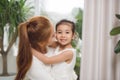 Happy loving family.Asian mother and child girl playing, kissing and hugging Royalty Free Stock Photo