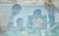 Happy loving family are baking together. Mother, father and two daughters are making cookies and having fun in the Royalty Free Stock Photo