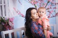 Happy loving family. Cute little girl is combing her mother`s hair