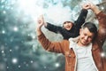 Happy loving family! Father and child girl having fun, playing and laughing on snowy winter walk in nature. Frost winter season. Royalty Free Stock Photo