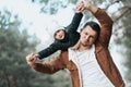 Happy loving family! Father and child girl having fun, playing and laughing on snowy winter walk in nature. Frost winter season. Royalty Free Stock Photo