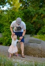 Happy loving family. Father and his daughter child girl playing and hugging outdoors. Cute little girl hugs daddy. Concept of