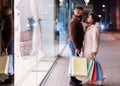 Happy black couple hugging and holding shopping bags Royalty Free Stock Photo