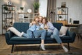 Happy loving family at home. Pretty young caucasian mother reading a book to her daughters Royalty Free Stock Photo