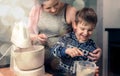 Happy loving family in the kitchen before Christmas. Mother and child preparing the dough, bake ginger cookies Royalty Free Stock Photo