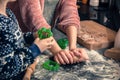 Happy loving family in the kitchen before Christmas. Mother and child preparing the dough, bake ginger cookies Royalty Free Stock Photo