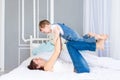 A happy, loving family. Mom and baby son play at home on the bed, have fun and laugh Royalty Free Stock Photo