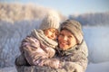 Mother and child girl having fun, playing and laughing on snowy winter. Royalty Free Stock Photo