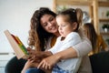 Happy loving family. Beautiful mother and child girl playing, kissing and hugging Royalty Free Stock Photo