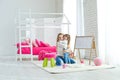 Happy loving family. Mother and daughter in the children`s room. Cute little girl is playing with a woman. Royalty Free Stock Photo