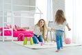 Happy loving family. Mother and daughter in the children`s room. Cute little girl is playing with a woman. Royalty Free Stock Photo