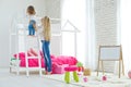 Happy loving family. Mother and daughter in the children`s room. Cute little girl is playing with a woman. Royalty Free Stock Photo