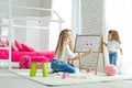 Happy loving family. Mother and daughter in the children`s room. Cute little girl is playing with a woman. Royalty Free Stock Photo