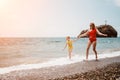 Happy loving family mother and daughter having fun together on the beach. Mum playing with her kid in holiday vacation Royalty Free Stock Photo