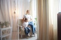 Happy loving family with mother and daughter in living room. Woman mom and small child girl playing and having Royalty Free Stock Photo