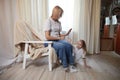 Happy loving family with mother and daughter in living room. Woman mom and small child girl playing and having Royalty Free Stock Photo