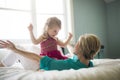 Happy loving family. Mother and her daughter child girl playing and hugging.on bed Royalty Free Stock Photo