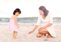 Happy loving family. Mother and her daughter child girl playing sand at the beach Royalty Free Stock Photo