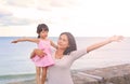 Happy loving family. Mother hugging her daughter child girl on sea background in the evening Royalty Free Stock Photo