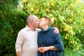 Happy loving family, old couple is kissing outdoor. Royalty Free Stock Photo