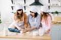 Happy loving family are preparing bakery together. Grandmother, two daughters and child granddaughter girl are baking Royalty Free Stock Photo