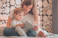 Happy loving family. Pretty young mother reading a book to her little son Royalty Free Stock Photo