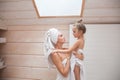 Happy loving family spending time together. Mother and her daughter child girl kissing and hugging in white bathroom. Woman and Royalty Free Stock Photo