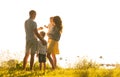 Happy loving family walking outdoor in the light of sunset. Father, mother, son and daughter. Royalty Free Stock Photo