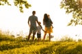 Happy loving family walking outdoor in the light of sunset. Father, mother, son and daughter. Royalty Free Stock Photo