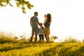 Happy loving family walking outdoor in the light of sunset. Father, mother, son and daughter. Royalty Free Stock Photo