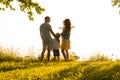 Happy loving family walking outdoor in the light of sunset. Father, mother, son and daughter. Royalty Free Stock Photo