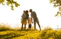 Happy loving family walking outdoor in the light of sunset. Father, mother, son and daughter. Royalty Free Stock Photo