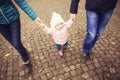 Happy loving family(mother, father and little daughter kid) outdoors walking having fun on a park in autumn season. Fallen yellow Royalty Free Stock Photo