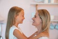 Happy loving family. Young mom and her beautiful daughter are looking at each other and smiling Royalty Free Stock Photo