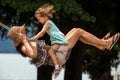 Happy loving family! Young mother and her child daughter swinging on the swings and laughing a summer evening outdoors, beautiful Royalty Free Stock Photo