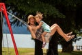 Happy loving family! Young mother and her child daughter swinging on the swings and laughing a summer evening outdoors, beautiful