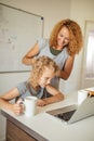 Smiling Mother helps her adorable daughter with homework Royalty Free Stock Photo