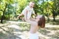 Happy loving mother and her baby having fun outdoors in the park Royalty Free Stock Photo