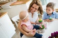 Happy and loving mother and her kids preparing home decoration Royalty Free Stock Photo