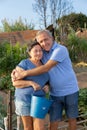 Happy loving older couple enjoying favorite pastime in garden