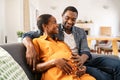 Happy loving pregnant black couple expecting baby Royalty Free Stock Photo