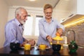 Loving senior couple having fun preparing healthy food on breakfast in the kitchen Royalty Free Stock Photo