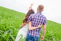 Happy loving young adult couple spending time on the field on sunny day Royalty Free Stock Photo