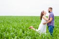 Happy loving young adult couple spending time on the field on sunny day Royalty Free Stock Photo